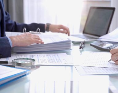 Payroll advisers analysing financial documents.
